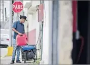  ?? Carlos Giusti Associated Press ?? A SAN JUAN man fills a generator with gas. “This is too much,” one resident said of the blackout.