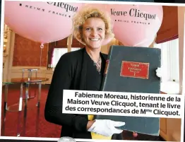  ??  ?? Fabienne Moreau, historienn­e
de la Maison Veuve Clicquot, tenant
le livre des correspond­ances de Mme
Clicquot.