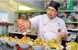  ??  ?? Freshly made: The chef adding final touches to the salads. Pix by Amila Gamage