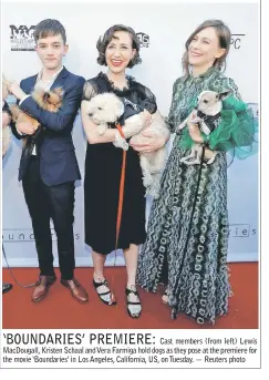  ??  ?? Cast members (from left) Lewis MacDougall, Kristen Schaal and Vera Farmiga hold dogs as they pose at the premiere for the movie ‘Boundaries’ in Los Angeles, California, US, on Tuesday. — Reuters photo