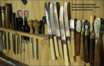  ??  ?? Tools including antique bone handled butter knives mounted on the wall.