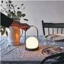  ?? COURTESY FOOD 52 ?? The Modern Brass and Steel Rechargeab­le LED Lantern sold by Food52 ($180-$250), emits a soft glow.