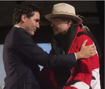  ?? ADRIAN WYLD/THE CANADIAN PRESS FILE PHOTO ?? Prime Minister Justin Trudeau with Gord Downie after he was presented with a star blanket at a ceremony in 2016.