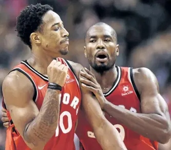  ?? FRANK GUNN/THE CANADIAN PRESS ?? Toronto guard DeMar DeRozan, left, celebrates a basket with forward Serge Ibaka.