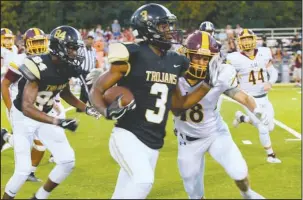  ?? The Sentinel-Record/Grace Brown ?? ON THE EDGE: Senior Hot Springs running back Damian Walker (3) carries the ball around Lake Hamilton’s Braden Braughton (18) a week ago during the Trojans’ 42-7 home loss on Tommy J. Holt Field at Joe C. Reese Stadium.