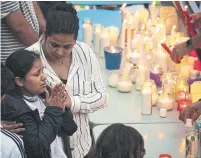  ?? STEVE MCKINLEY TORONTO STAR ?? Rajveer Kaur, the sister of murdered taxi driver Prabhjot Singh, is comforted by a friend during a vigil in Truro, N.S., on Friday. Singh, 23, was murdered outside his apartment Sept. 5.