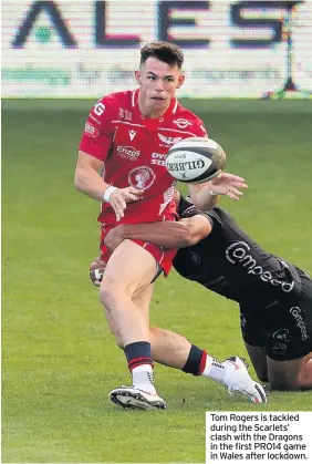  ??  ?? Tom Rogers is tackled during the Scarlets’ clash with the Dragons in the first PRO14 game in Wales after lockdown.