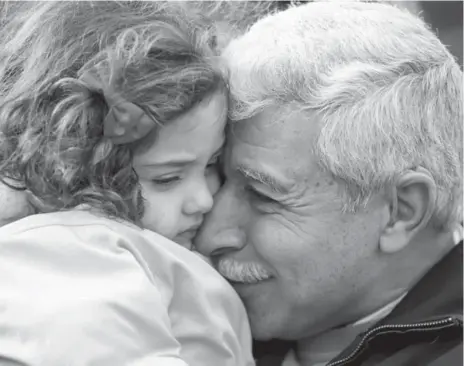  ?? MARCK BLINCH/REUTERS ?? Hagop Karageozia­n, a Syrian refugee who arrived in Canada on Friday, is reunited with his granddaugh­ter at the Armenian Community Centre of Toronto.