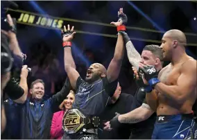  ?? DAVID BECKER — THE ASSOCIATED PRESS ?? Jon Jones, center, celebrates after defeating Ciryl Gane in a UFC 285mixed martial arts heavyweigh­t title bout Saturday, March 4, 2023, in Las Vegas.