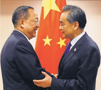  ?? BULLIT MARQUEZ, AP ?? North Korean Foreign Minister Ri Yong Ho, left, is greeted by his Chinese counterpar­t, Wang Yi, Sunday in Manila.