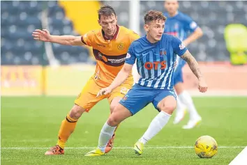  ??  ?? Kilmarnock’s Callum McFadzean, right, pulls away from Motherwell’s Craig Clay.