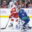  ?? The Canadian Press ?? Henrik Zetterberg of the Detroit Red Wings looks for a rebound in front of Vancouver Canucks goalie Jacob Markstrom during Monday’s game.