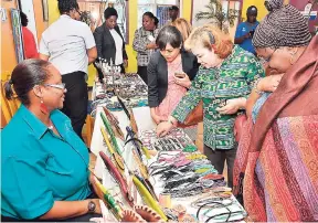  ??  ?? Local entreprene­ur and co-owner of Devine Treasures, Cheryl Thomas-Whytehead (left), displays locally made craft items at the Jamaica Business Developmen­t Corporatio­n, 14 Camp Road, Kingston, earlier this year.