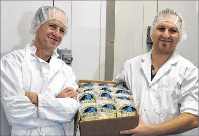  ?? DESIREE ANSTEY/ JOURNAL PIONEER ?? Albert Arsenault, the cheese maker, and Mathieu Gallant, the owner of The Island Artisan Cheesehous­e, hold a box of Squeak-ies.