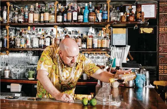  ?? JASON HENRY / NYT ?? Martin Cate, rum expert and author of “Smuggler's Cove: Exotic Cocktails, Rum, and the Cult of Tiki,” makes a Ti Punch using rhum agricole, sugar cane syrup and lime. Two rums, distilled from pure sugar cane juice rather than molasses, have intrigued bartenders.