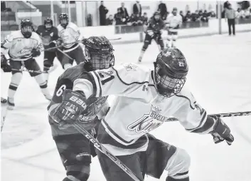  ?? [FAISAL ALI / THE OBSERVER] ?? Mason McMahon battles the visiting Cambridge Redhawks for the puck at a home game Oct. 27. It was a close affair, but Elmira ultimately squeaked by with a 2-1 victory.