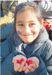  ??  ?? Sahara Mason, 7, of Dunedin, is delighted with her free Jaffas.