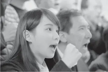  ?? ASSOCIATED PRESS ?? Agnes Chow, 21 years old, a member of democracy activist Joshua Wong's Demosisto party, shouts slogan during a press conference in Hong Kong yesterday.