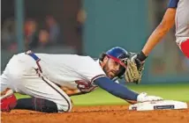  ?? AP PHOTO/JOHN BAZEMORE ?? Atlanta Braves’ Dansby Swanson steals second base in the third inning against the Boston Red Sox on Wednesday in Atlanta.