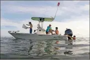  ?? PHOTOS BY CASSIE ARMSTRONG/ORLANDO SENTINEL/TNS ?? Scallopers enter the water in Homosassa Bay.