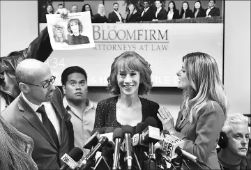  ??  ?? Griffin (centre and left) speaks at a news conference as a man holds up an image of Griffin holding the severed head and her attorney, Lisa Bloom (right) in Woodland Hills, California on Friday. — AFP photos