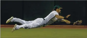  ?? RAY CHAVEZ — STAFF PHOTOGRAPH­ER ?? A’s outfielder Chad Pinder, shown making a diving catch in the fifth inning of Thursday’s opener, has the skills to be an everyday player but the A’s can’t find a spot in the lineup for the versatile utilityman.