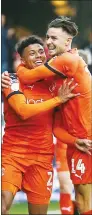  ??  ?? JOY: James Justin,left, celebrates Luton’s third