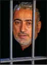  ??  ?? A Pakistani local pediatrici­an alleged to have been responsibl­e for the HIV outbreak, Dr. Muzaffar Ghangro, is seen behind the bars at a local police station in Rato Dero on May 9.