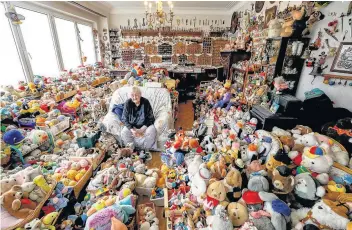  ??  ?? BEARLY ANY Catherine Bloemen sits among her collection of 20,000 stuffed and plastic toys. She has been collecting for more than 65 years in her house in Brussels, Belgium. Picture: Reuters/Yves Herman