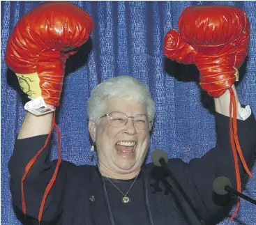  ?? JACQUES BOISSINOT / THE CANADIAN PRESS ?? Conservati­ve MP Elsie Wayne raises her hands after receiving a pair of boxing gloves at her nomination meeting in Saint John, N.B., in 2000. She held the seat for almost 11 years and retired undefeated.