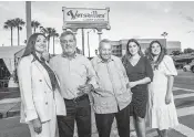  ?? PEDRO PORTAL pportal@miamiheral­d.com ?? Felipe Valls Sr., founder of Versailles, with his son, Felipe Valls Jr., and granddaugh­ters, from left, Nicole, Luly and Desirée, in front of the restaurant on Calle Ocho.
