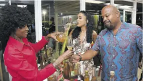  ?? ?? Sista Love Wines principal Princess Mclarty poured Bamboo Wine for guest judge Karl Tulloch, as Jamaica Observer Table Talk Food Awards judge Mala Morrison relished a glass of the same.