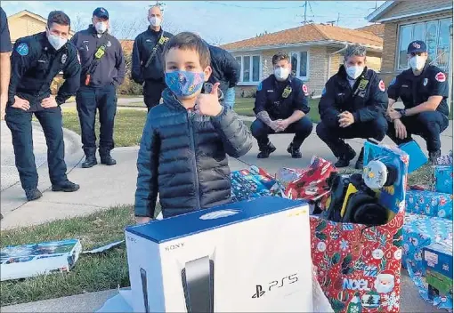  ?? PROJECT FIRE BUDDIES ?? The Oak Lawn chapter of Project Fire Buddies met its first buddy, AJ, on Dec. 22. AJ is battling leukemia, and the firefighte­rs involved with the nonprofit tried to make his Christmas a little brighter with a PlayStatio­n 5 and a mountain of other gifts.