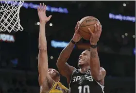  ?? MARK. J. TERRILL — ASSOCIATED PRESS ?? Spurs guard DeMar DeRozan, right, shoots as Lakers forward Johnathan Williams defends during the second half of game on Oct. 22 in Los Angeles. The Spurs won, 143-142.
