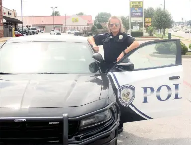  ?? Marc Hayot/Herald Leader ?? Officer DeAndra Strickland poses with her police cruiser. Since the schools shut down because of the coronaviru­s pandemic she has been working patrol.