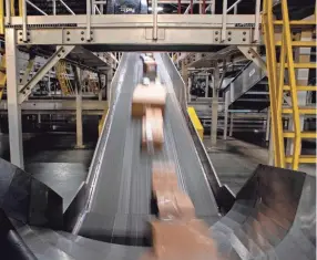  ?? MAX GERSH/THE COMMERCIAL APPEAL ?? Packages move along a conveyor belt Dec. 4, 2019, at the Fedex Ground Olive Branch hub.