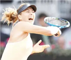  ?? — AFP photo ?? Sharapova returns the ball to Australia’s Dar’ja Gavrilova during Rome’s WTA Tennis Open tournament at the Foro Italico in Rome.