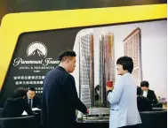  ?? WU CHANGCHUN / FOR CHINA DAILY ?? People consult for rates of residentia­l houses in Dubai at an overseas properties fair in Beijing. Many Chinese HNWIs plan to buy properties overseas in the future.