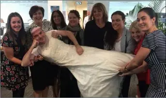  ??  ?? Davey Caulwell and his colleagues in Servisourc­e when he wore his wife’s wedding dress for the Today FM’s Dare to Care Wedding Dress Wednesday challenge