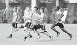  ?? SUSAN STOCKER / SOUTH FLORIDA SUN SENTINEL ?? Inter Miami’s Josh Penn (center) runs through a drill on Tuesday at the Inter Miami CF Training Center in Fort Lauderdale.