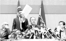  ??  ?? Malaysian Anti-Corruption Commission Chief Commission­er Datuk Seri Mohd Shukri Abdull showing a copy of the report on the 1Malaysia Developmen­t Berhad (1MDB) probe at a press conference yesterday. - Bernama photo