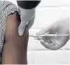  ?? SIPHIWE SIBEKO/AP ?? A volunteer receives an injection at Chris Hani Baragwanat­h hospital in Soweto, Johannesbu­rg, as part of a COVID-19 vaccine trial.