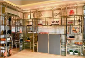  ??  ?? Customized metal display shelving is the design solution to the lack of walls.