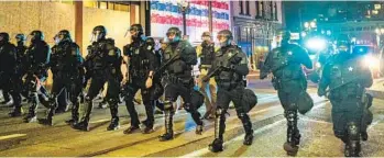  ?? MASON TRINCA NYT ?? Police in riot gear work to disperse a crowd in Portland, Ore., on Nov. 4, 2020. A city police training slideshow from 2018 concluded with a meme that mocked protesters and celebrated violence against them.