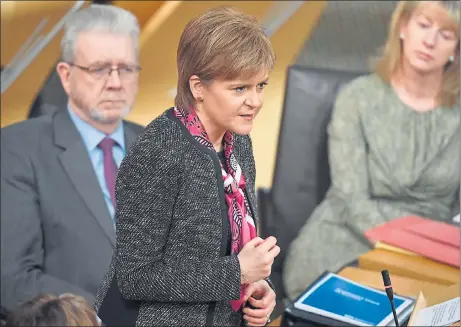  ??  ?? MAKING HER CASE: First Minister Nicola Sturgeon explains her proposals in the Scottish Parliament, as Brexit Minister Mike Russell looks on. Picture: Jeff Mitchell/Getty