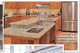  ??  ?? KITCHEN HAS COUNTERTOP­S AT DIFFERENT LEVELS