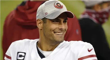  ?? GETTY IMAGES; TOP, NANCY LANE / HERALD STAFF ?? ‘READY FOR HIS BEST’: San Francisco 49ers quarterbac­k Jimmy Garoppolo smiles during the third quarter against the Los Angeles Rams on Sunday in Santa Clara, Calif. At top, Patriots coach Bill Belichick talks with his coaches on the sidelines during the first half on Sunday against the Broncos.