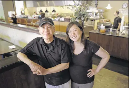  ?? PHOTOS BY NIKKI BOERTMAN/THE COMMERCIAL APPEAL ?? Fathers who labor alongside their kids in family-run restaurant­s include Eddie Pao, whose daughter, Michelle Pao Levine, works with him at Mosa.