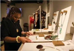  ?? ?? A staff member arranges a display of Shah’s hand-crafted jewellery at a showcase of designs by several local artists, called Jamaa (swahili for community) fashion pop-up, in Nairobi.