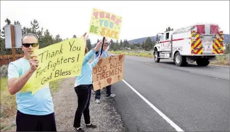  ?? Photog r aphs by Lawrence K. Ho
Los Angeles Times ?? BIG BEAR residents welcome f ire crews. Nearly 2,300 f iref ighters have battled the blaze that started June 17, and four have been injured.